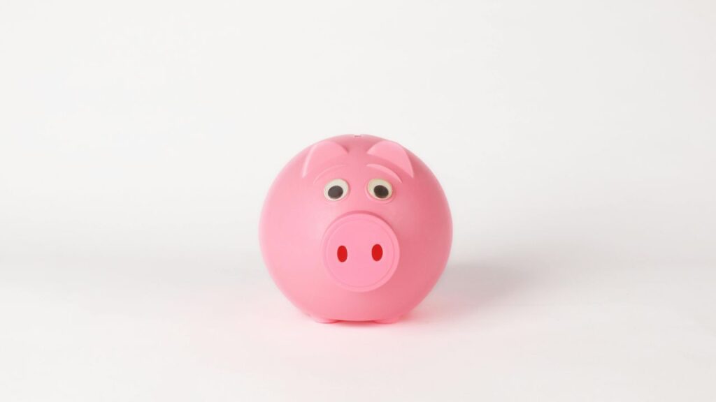 A pink piggy bank representing the importance of teaching kids about money and saving from an early age in the UK