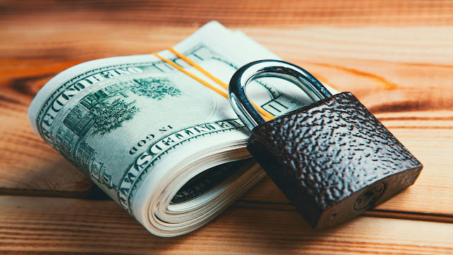 Divorce finances paperwork and wedding rings on a table