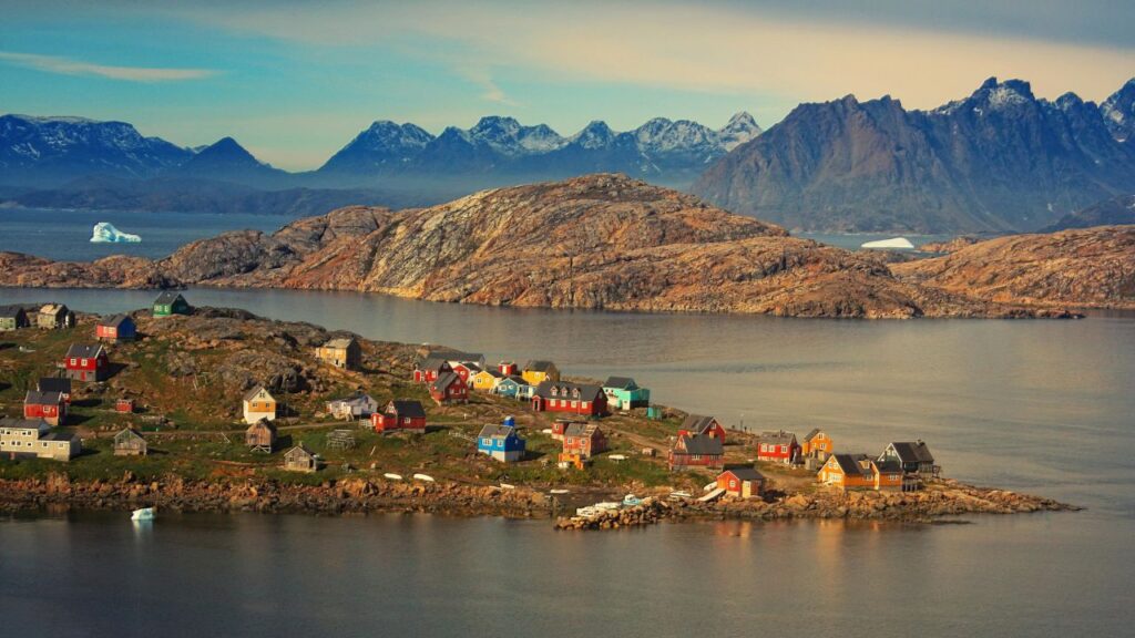 Greenland landscape with houses representing rare earth mineral investment opportunities and Arctic resources.