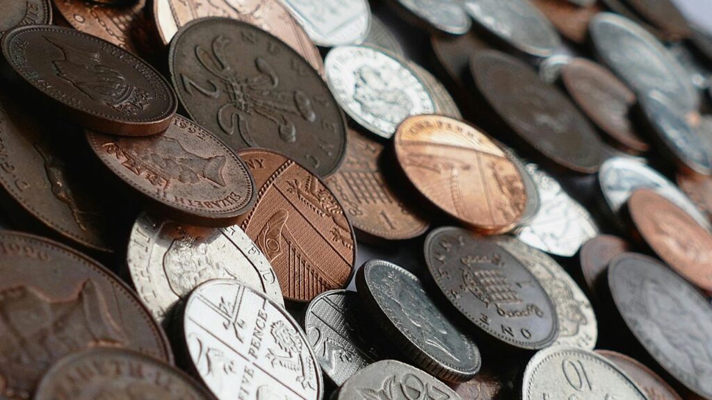 A pile of coins representing the tax savings available through a salary sacrifice pension for UK employees