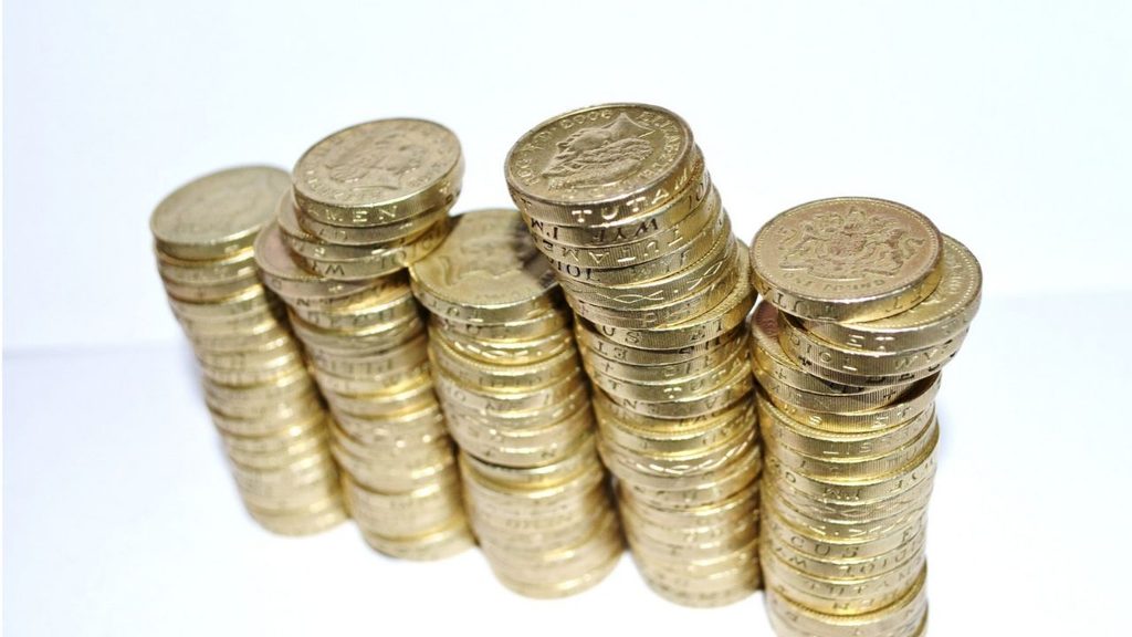 Stacks of pound coins representing dividend income kept tax free in a stocks and shares ISA